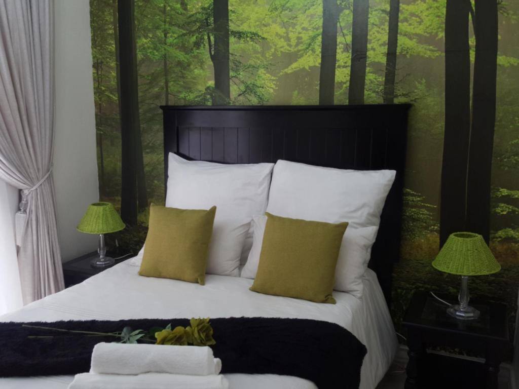Double bed with forest mural at Casa Angelo